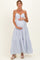 woman wearing a blue and white striped maternity maxi dress, holding her baby bump with a smile