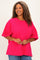 woman wearing a bright pink oversized t-shirt with short sleeves and a relaxed fit