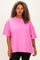 woman wearing a bright pink oversized t-shirt with short sleeves and a relaxed fit