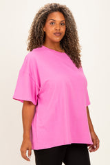 woman wearing a bright pink oversized t-shirt with short sleeves and a relaxed fit