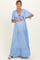 woman wearing a light blue maternity maxi dress with flutter sleeves and a tie detail, holding her baby bump