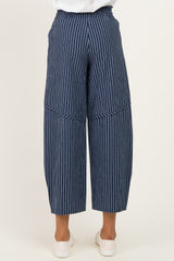woman wearing navy and white striped wide-leg trousers, shown from the back