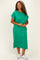 woman wearing a green plus-size midi dress with short sleeves and a pocket detail