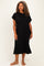 woman wearing a black short sleeve plus size t-shirt dress with a pocket on the chest