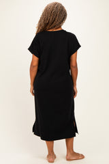 woman wearing a black midi dress with short sleeves and side slits, shown from the back