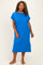 woman wearing a bright blue plus-size casual dress with short sleeves and a front pocket, standing confidently