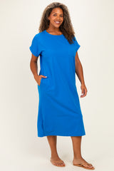 woman wearing a bright blue short sleeve plus-size dress with a pocket and relaxed fit
