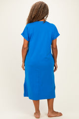 woman wearing a bright blue plus size midi dress with short sleeves and side slits, seen from the back