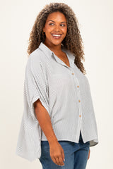 woman wearing a striped button-up plus size shirt with a relaxed fit and rolled sleeves