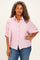 woman wearing a pink and white striped plus size button-up shirt with short sleeves and a relaxed fit, paired with blue jeans