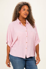 woman wearing a red and white striped plus size blouse with a button-down front and short sleeves