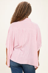 plus-size woman wearing a red and white striped oversized blouse with flutter sleeves seen from the back