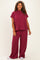 woman wearing a maroon ribbed knit plus size loungewear set with a short sleeve top and wide leg pants