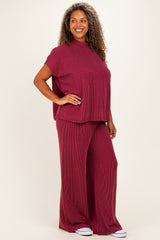 woman wearing a maroon knitted short sleeve top and matching wide-leg pants in a relaxed fit