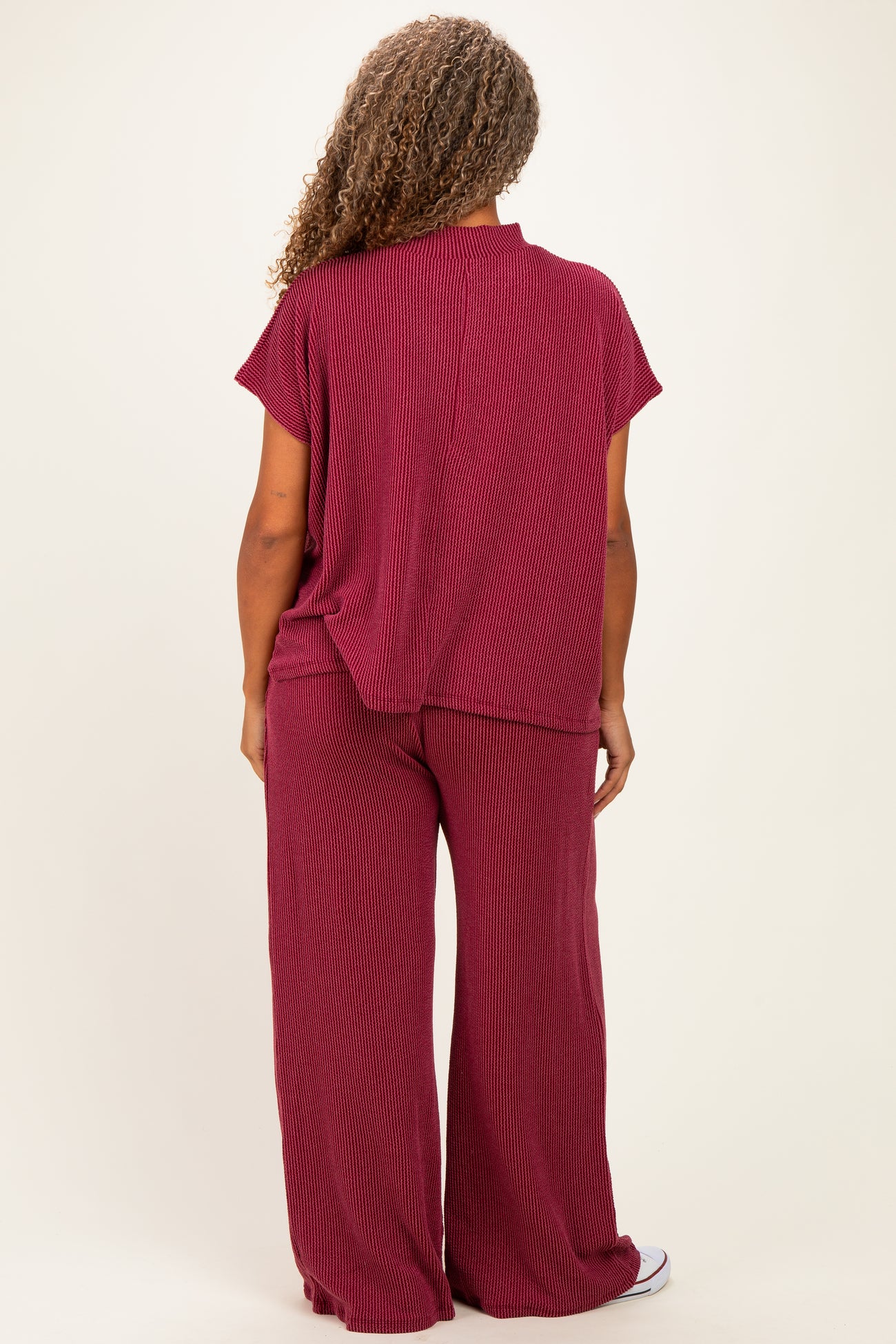 woman wearing a maroon lightweight plus size lounge set with a relaxed top and wide-leg pants