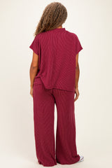 woman wearing a maroon lightweight plus size lounge set with a relaxed top and wide-leg pants