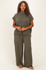 woman wearing a dark green striped plus size lounge set with a short-sleeve top and wide-leg pants