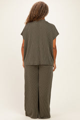 woman wearing a dark olive green short sleeve plus size top and matching wide leg pants, viewed from the back
