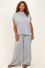 woman wearing a light gray ribbed knit short sleeve top and matching wide leg pants in plus size