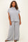 woman wearing a light gray ribbed knit short sleeve top and matching wide leg pants in plus size