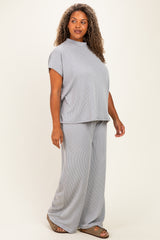 woman wearing a gray ribbed matching top and wide-leg pants in plus size, standing and smiling
