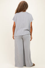 woman wearing a light gray and white striped plus size lounge set with wide leg pants and short sleeves, seen from the back
