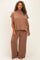 woman wearing a brown ribbed short sleeve top and matching wide-leg pants in plus size