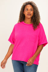 woman wearing a bright pink oversized ribbed t-shirt with a chest pocket and rolled sleeves