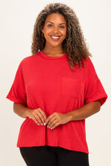 woman wearing a red short sleeve plus size top with a textured fabric and a front pocket