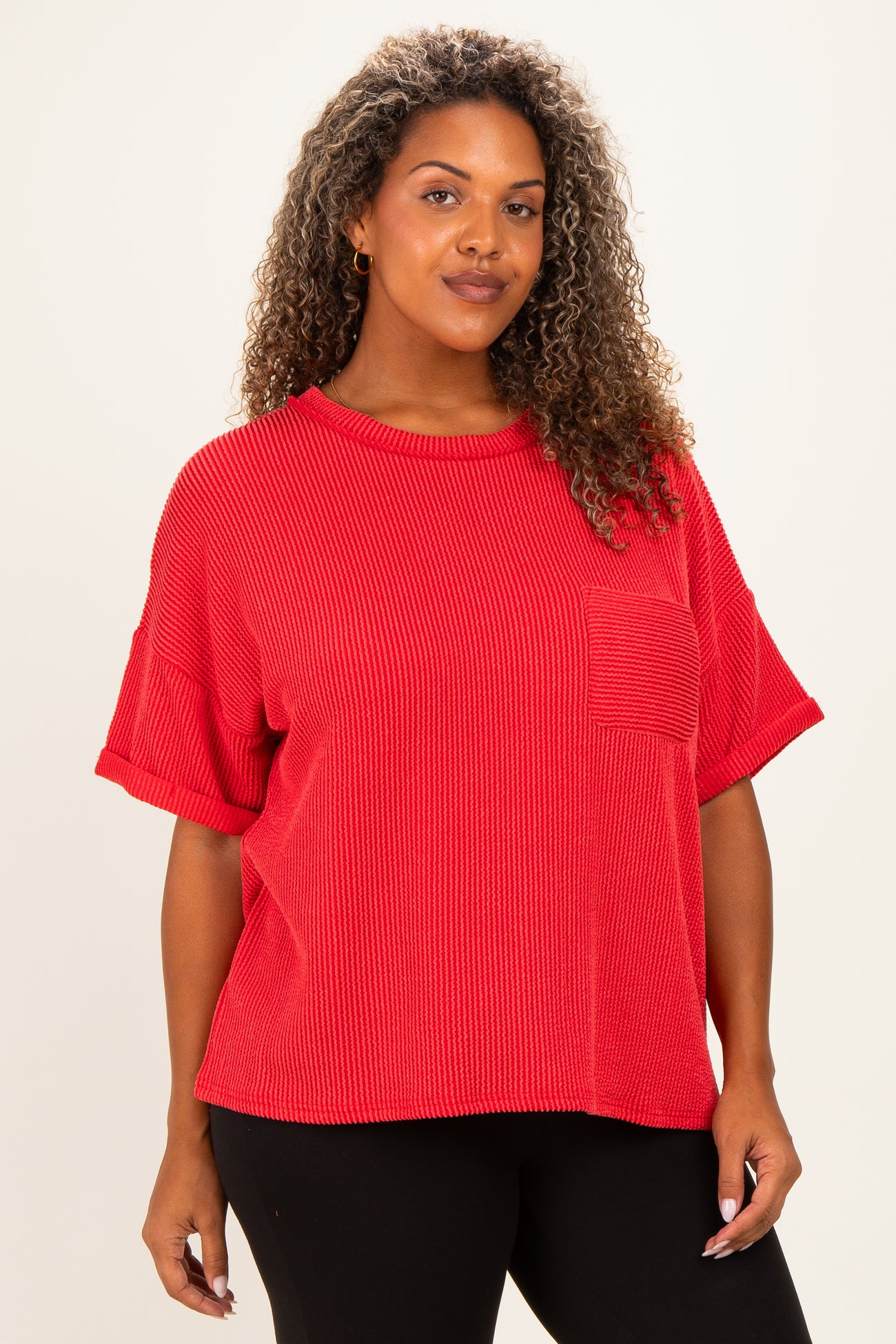 woman wearing a red short sleeve plus size top with a pocket and a relaxed fit