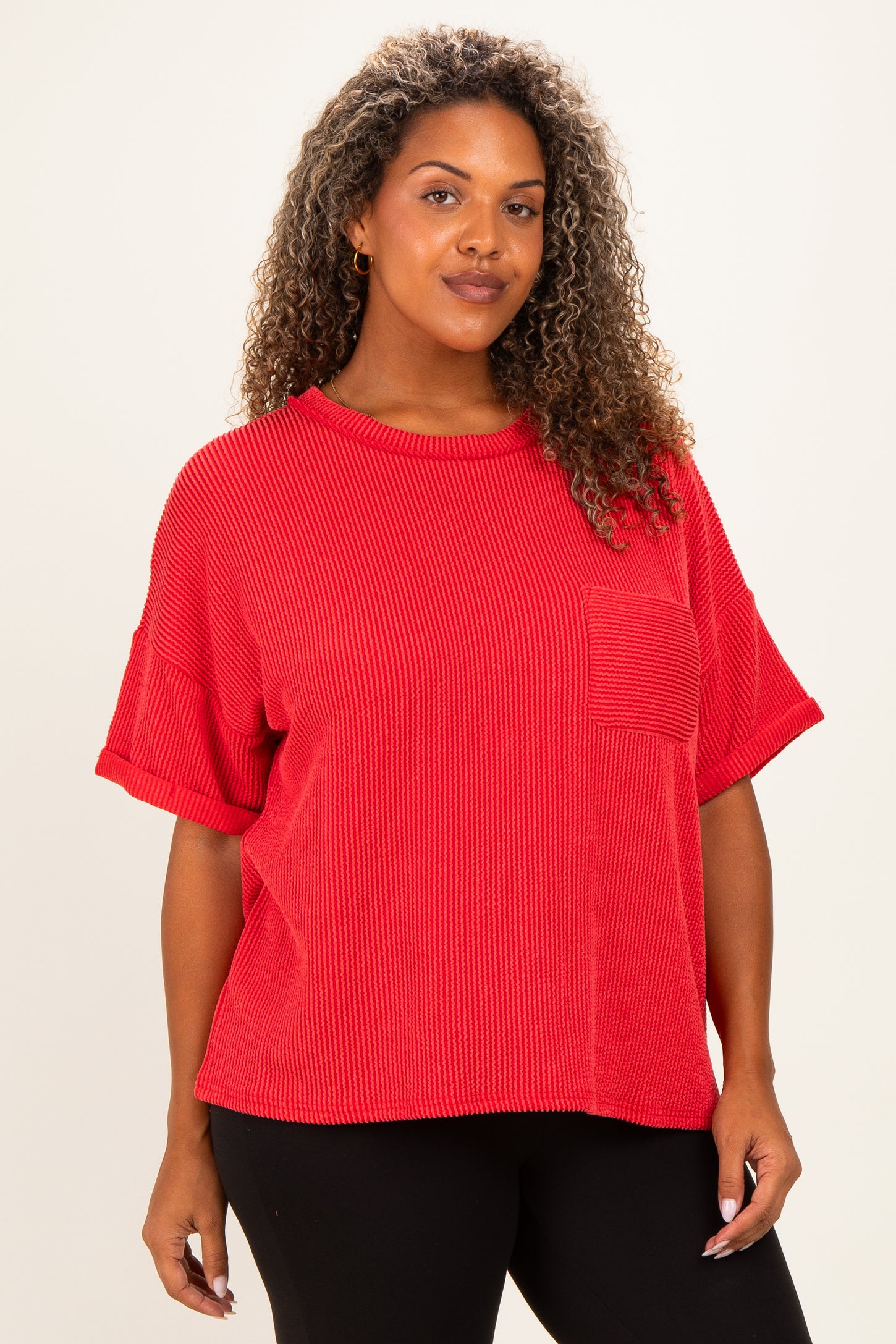 woman wearing a red short sleeve plus size top with a pocket and a relaxed fit