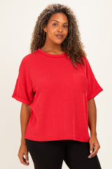 woman wearing a red short sleeve plus size top with a pocket and a relaxed fit