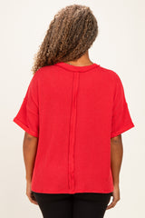 woman wearing a red oversized short sleeve sweater with a textured finish and back seam detail