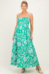 woman wearing a green floral maternity maxi dress with adjustable straps and a fitted bodice, baby bump visible