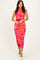 woman wearing a vibrant pink floral midi dress with a fitted silhouette and high neckline