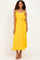 woman wearing a sleeveless yellow maxi dress with knot detail at the waist and delicate straps