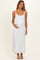 woman wearing a white maternity maxi dress with adjustable straps and a drawstring waist, holding her baby bump