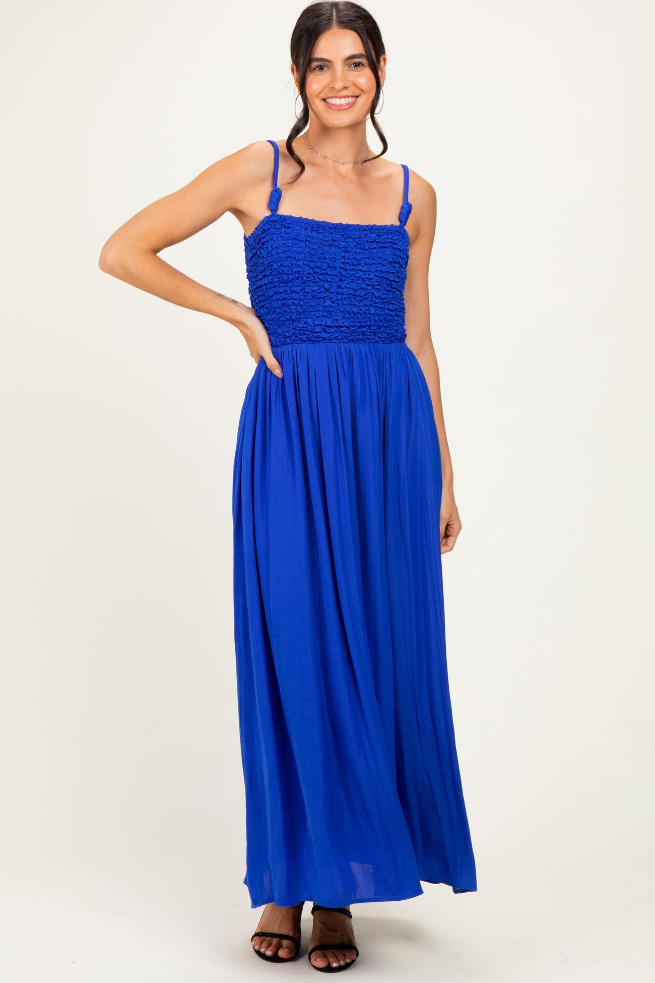 woman wearing a vibrant blue maxi dress with a smocked bodice and thin straps