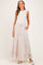 woman wearing a white sleeveless top and a floral printed maxi skirt with pockets, styled for maternity wear
