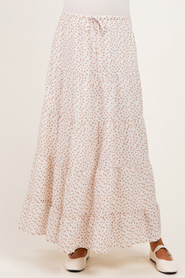 woman wearing a white floral maternity maxi skirt with three tiers and a drawstring waist
