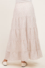 woman wearing a white floral print maternity maxi skirt with tiered design, seen from the back