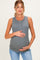 woman wearing a gray ribbed maternity tank top and holding her baby bump