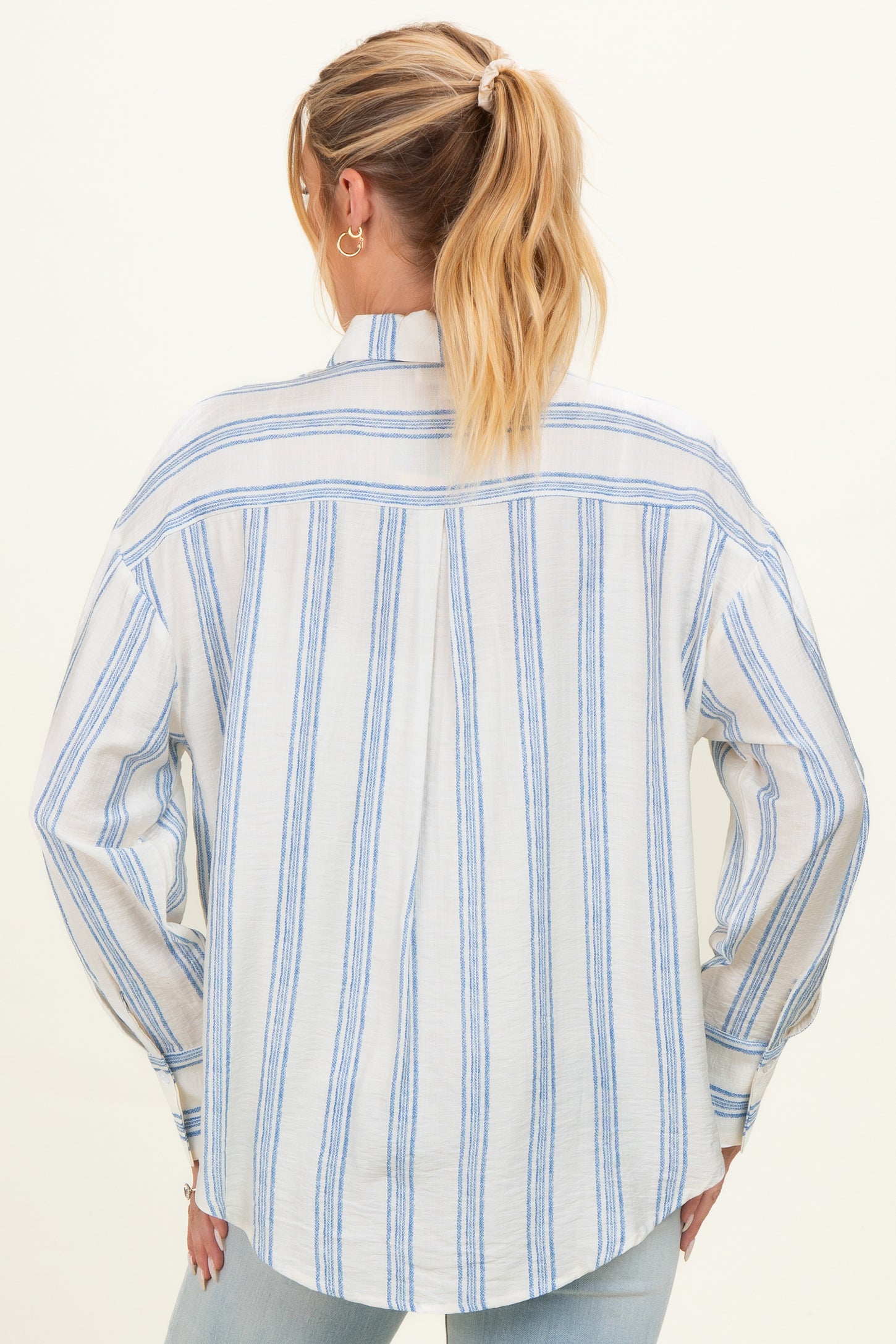 maternity wear oversized light blue and white striped shirt, shown from the back with relaxed fit and long sleeves