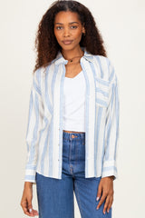 woman wearing a white and blue striped button-up shirt with a chest pocket and light wash jeans