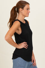 woman wearing a black ribbed sleeveless top with a rounded hem and side slits