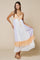 woman wearing a lavender and peach color-blocked maxi dress with a ruffle hem and adjustable spaghetti straps
