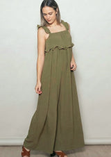 woman wearing an olive green maxi dress with ruffled straps and a relaxed fit