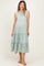 woman wearing a mint green sleeveless maternity dress with a v-neck and tiered skirt, showing a baby bump