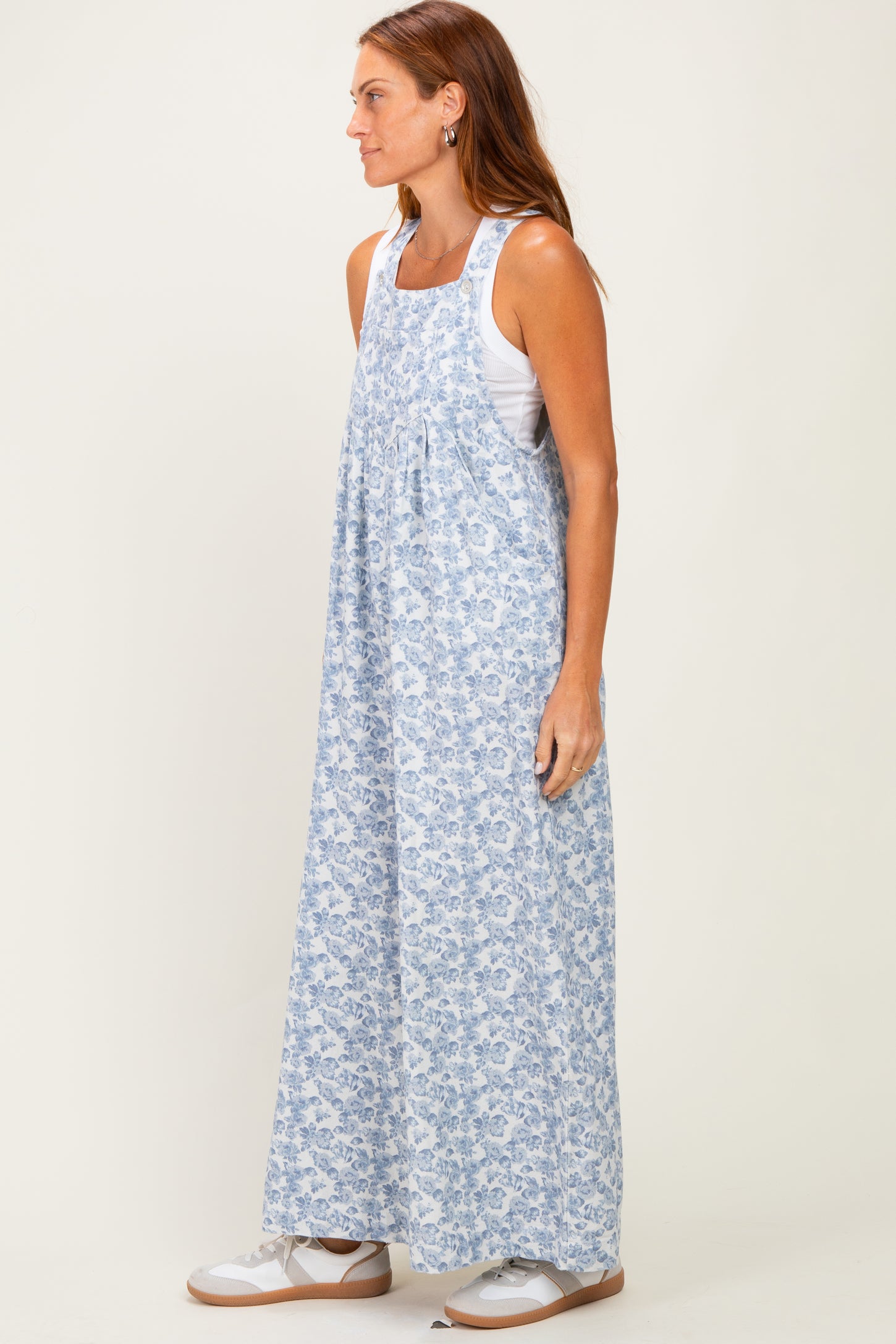 woman wearing a light blue floral maxi dress with a loose fit and wide straps
