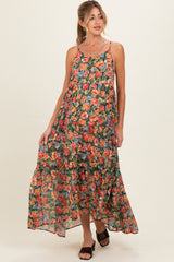 woman wearing a floral maxi maternity dress with spaghetti straps and a tiered hemline